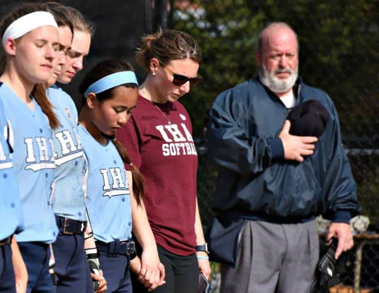 IHA coach Diana Fasano, second from right, stands with her players before Friday’s first game of the season.